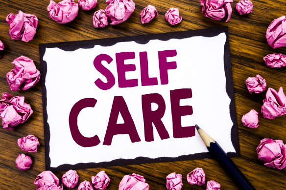 Hand writing text caption inspiration showing Self Care. Business concept for Taking caring for own Health Written on sticky note paper, wooden background with folded pink paper meaning thinking